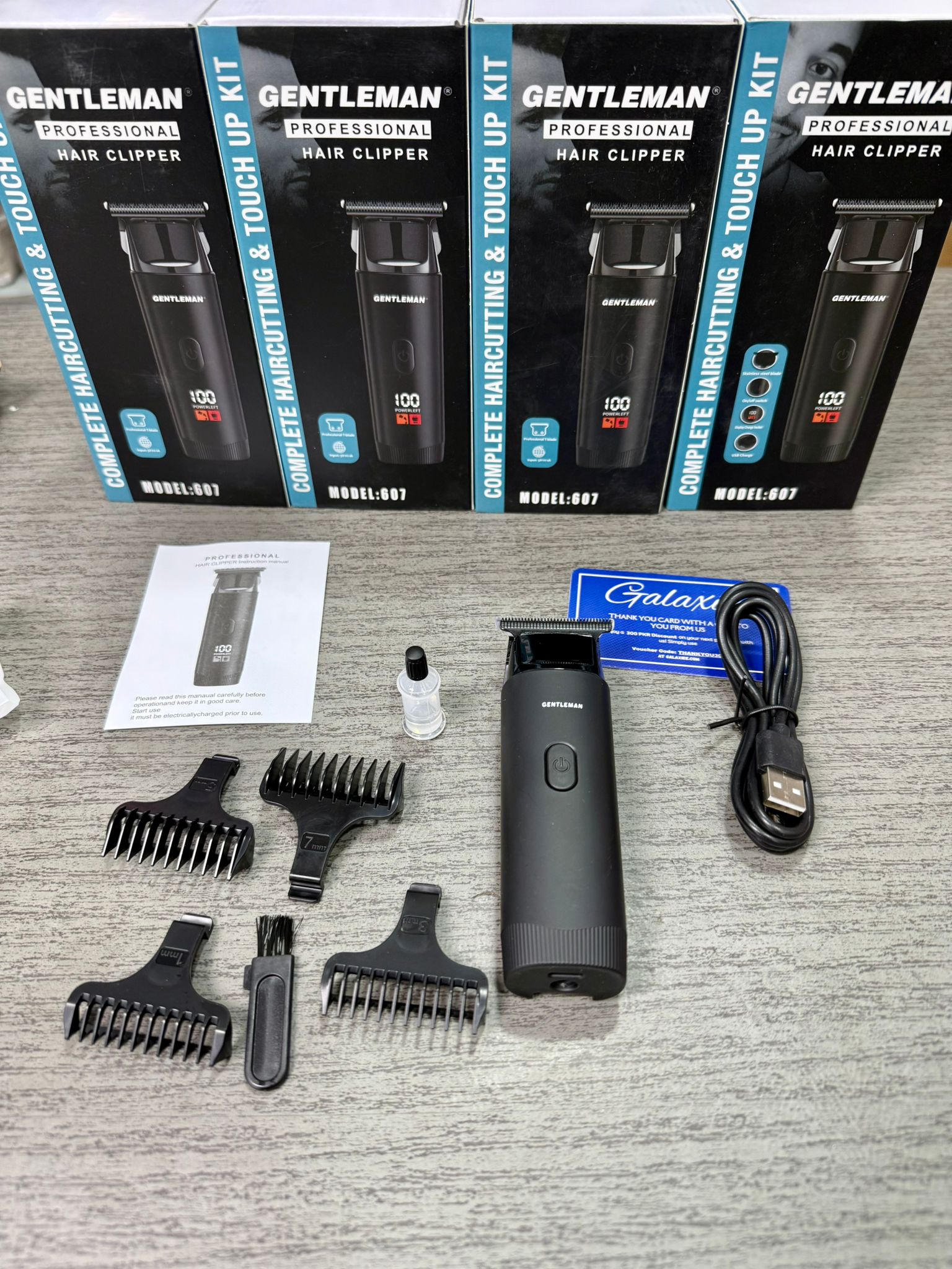 Gentleman grooming kit with hair clipper, attachments, and packaging.